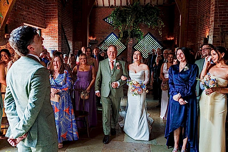 Joyful wedding ceremony with laughing bride and groom.