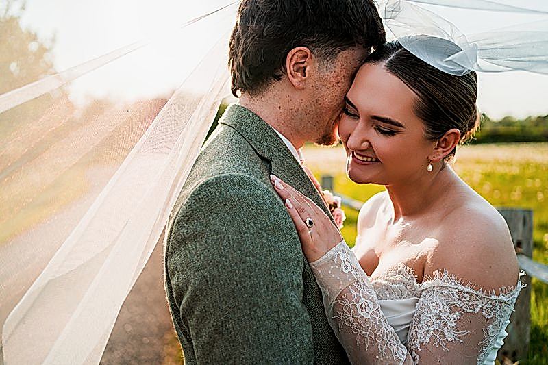 Bride and groom embracing on wedding day.